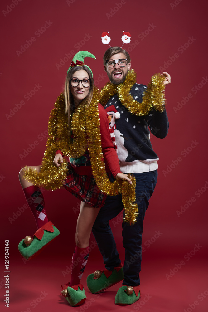 Young couple wearing funny Christmas clothes