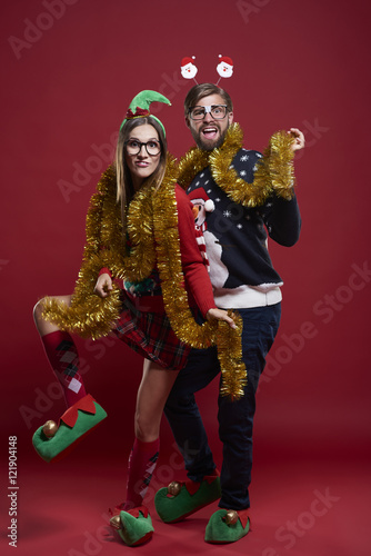 Young couple wearing funny Christmas clothes