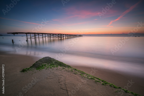 Sunrise at the Black sea coast / Magnificent sea sunrise with an old broken bridge near Varna, Bulgaria