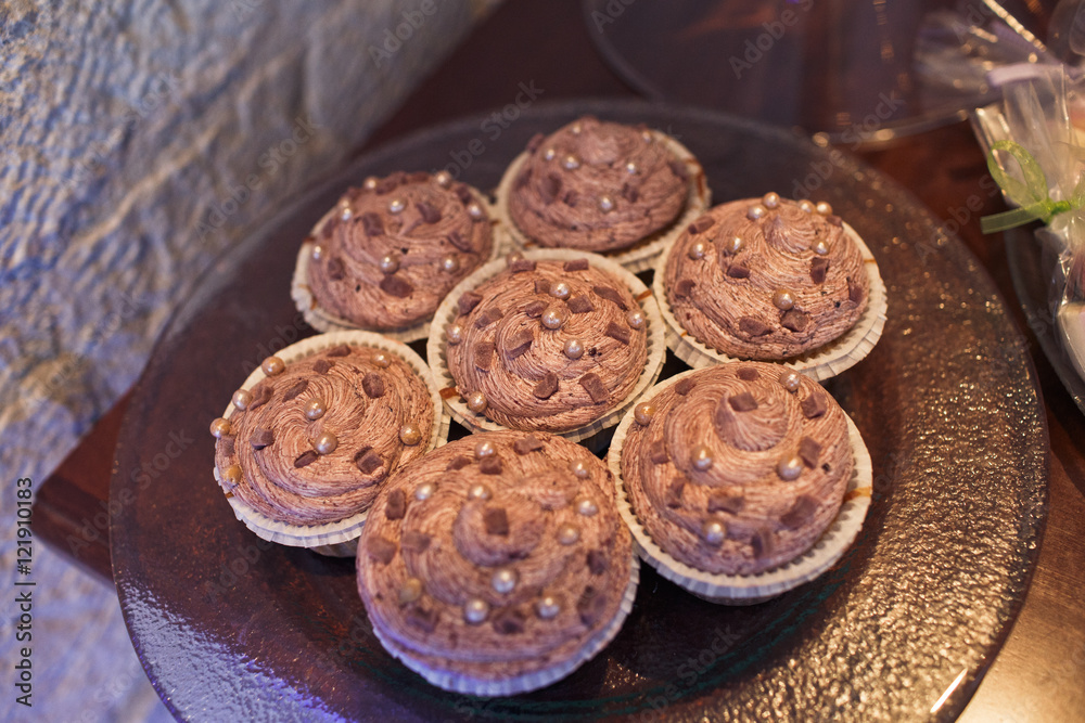 Fototapeta premium Delicious cupcakes with pastel cream stand on glass dish