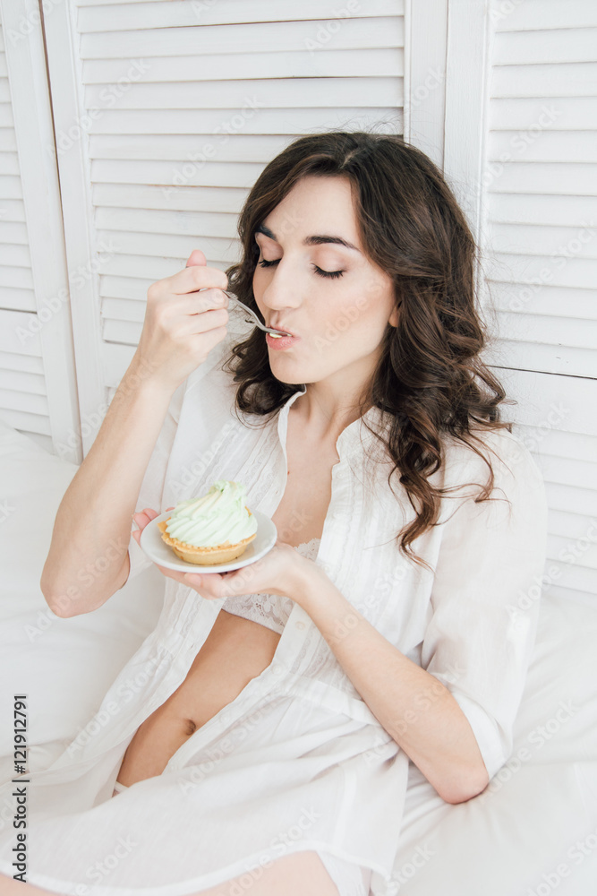 Girl eats cake for Breakfast in bed