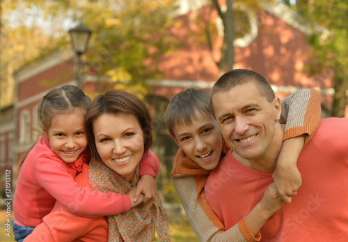 Family relaxing in autumn park