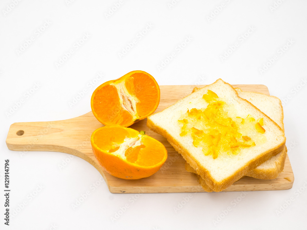 Fresh orange with orange jam and bread on wooden tray over white background. Fresh orange with orange jam and bread on wooden tray over white background.