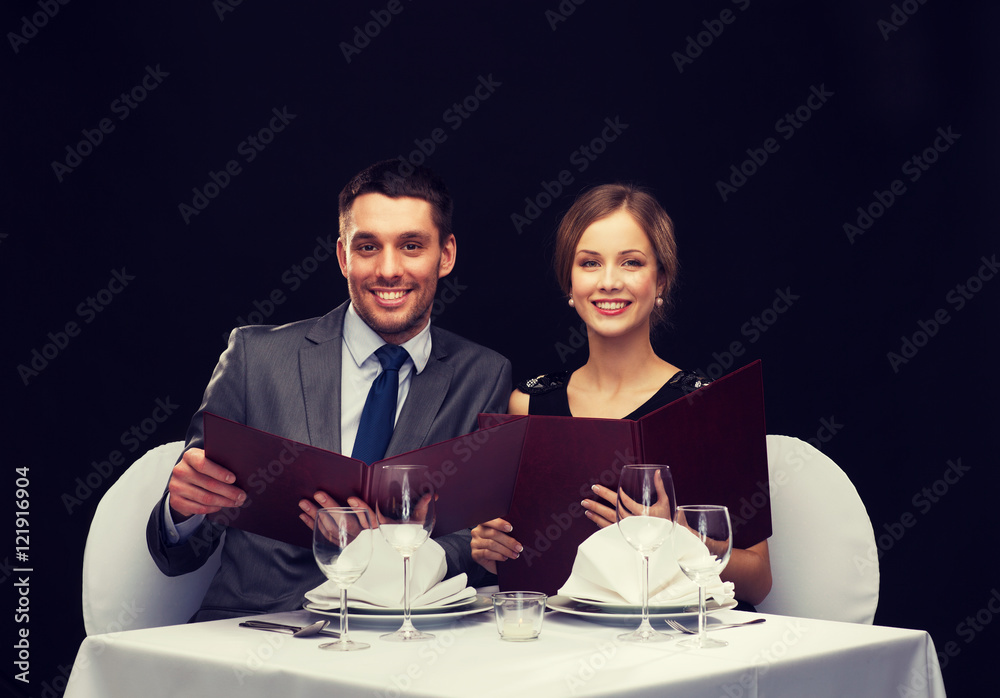 smiling couple with menus at restaurant smiling couple with menus at restaurant