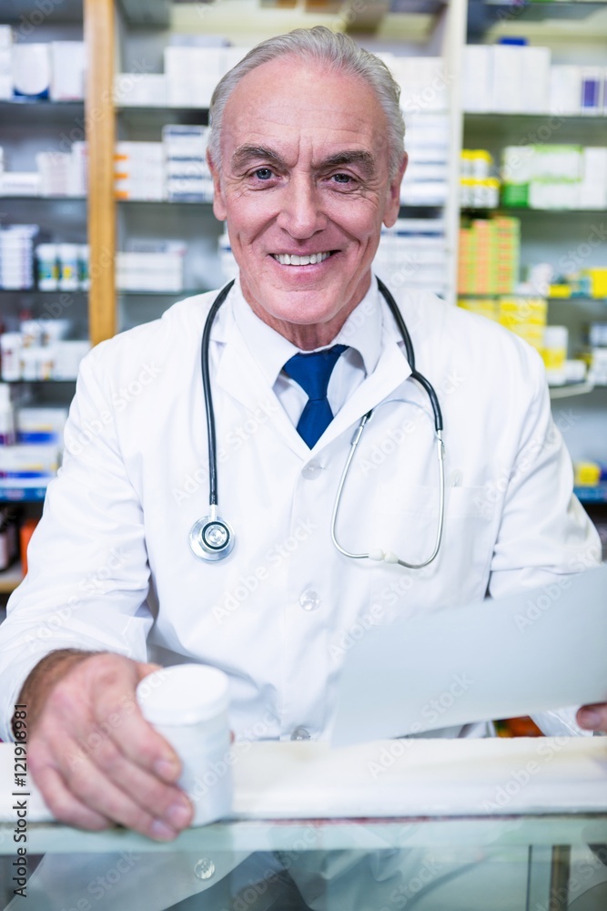 Pharmacist holding a prescription and medicine Pharmacist holding a prescription and medicine