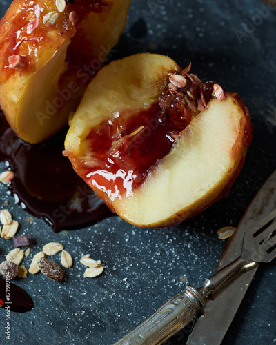 baked apple with caramellized sugar, strawberry topping, cereal and racin photo