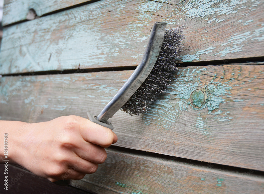 Remove the old paint from the wooden surface. Use a wire brush to strip the  paint from the old wooden wall. Stock Photo | Adobe Stock