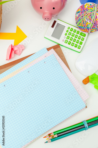 Work place of a creative person with a variety of colorful stationery objects