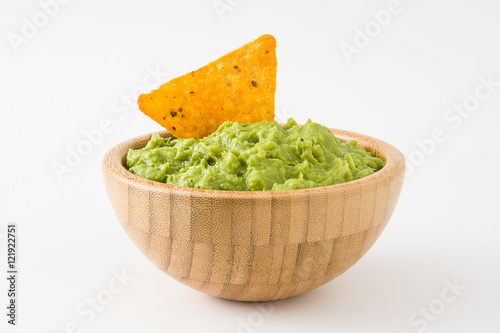Guacamole in a wooden bowl isolated on white background
 photo