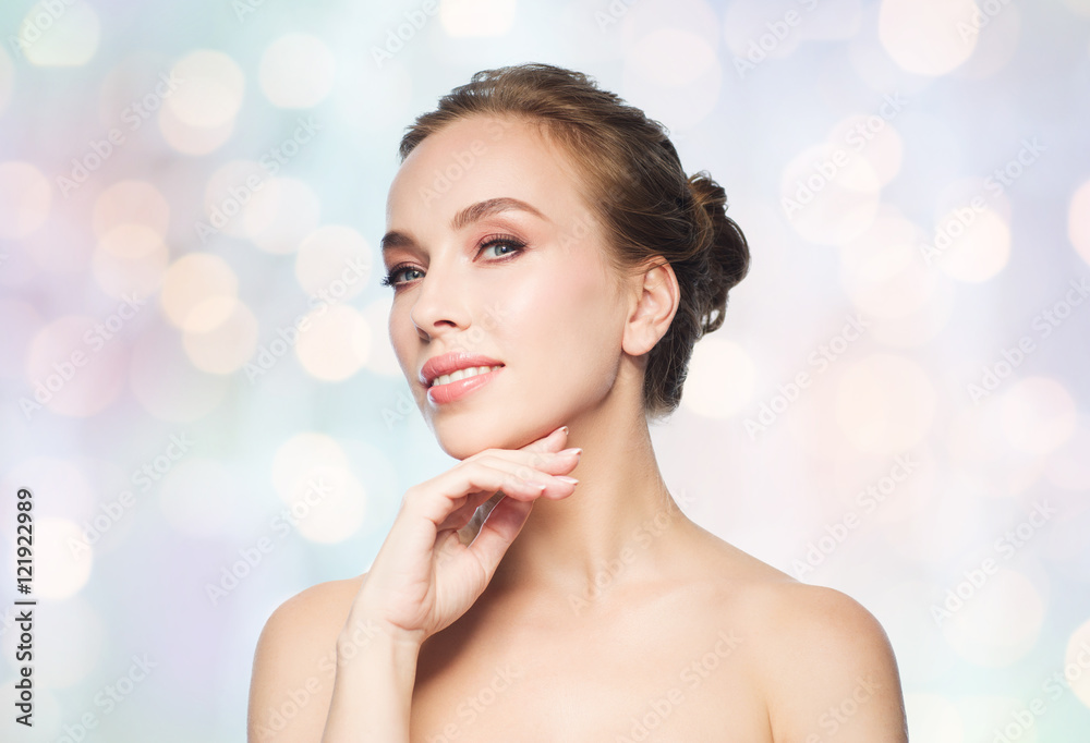 Fototapeta premium beautiful young woman touching her face