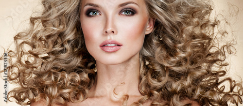 Beautiful blonde woman. Healthy Long Blond Hair. Curly Hair. B