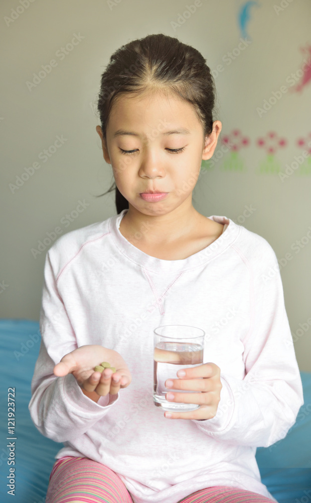 Young Asian girl patient with long black hair don't want to eat medicine pills for health and illness concept.