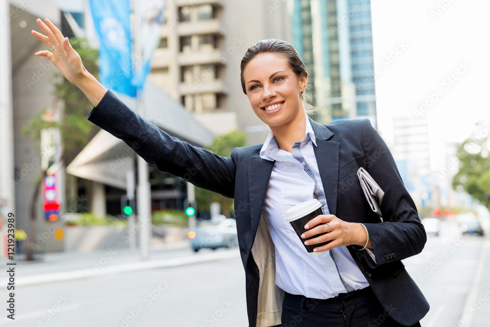 Portrait of business woman catching taxi Portrait of business woman catching taxi