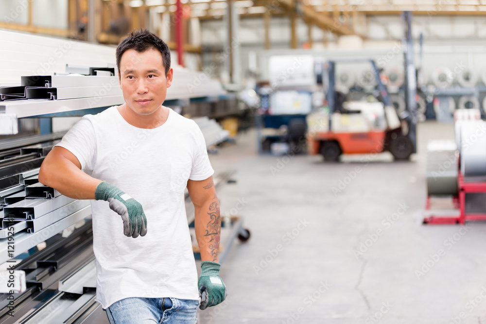 Asian worker in production plant on the factory floor Asian worker in production plant on the factory floor