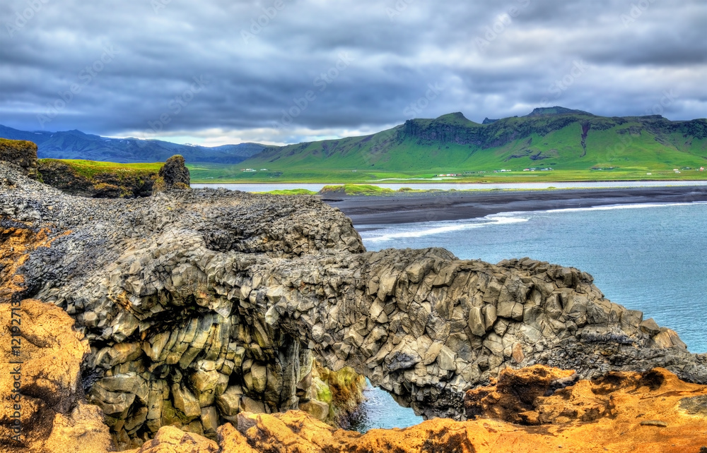 Natural basalt arch at Dyrholaey Cape - Iceland Natural basalt arch at Dyrholaey Cape - Iceland