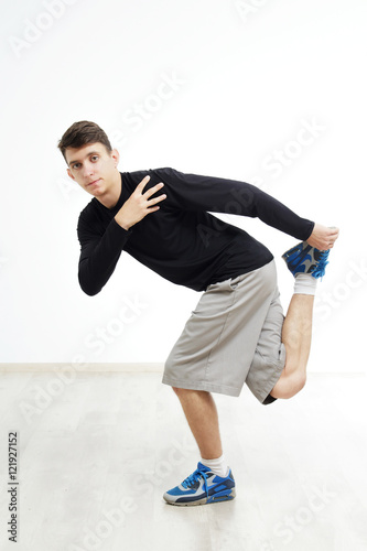 Hip hop dancer performing isolated over white background. Hip hop performer is standing in hip hop pose.