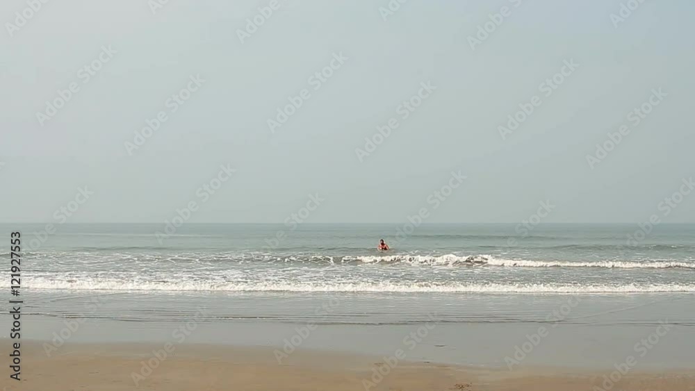 Happy young man swimming on the beach Happy young man swimming on the beach