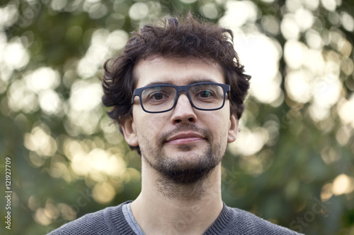 Happy young man looking at camera on a sunny day.
