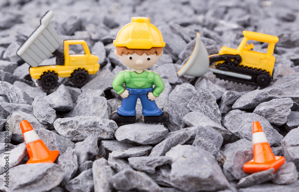 worker,dumper truck and bulldozer on pebbles