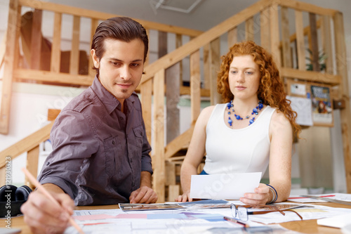 Two young architects in office