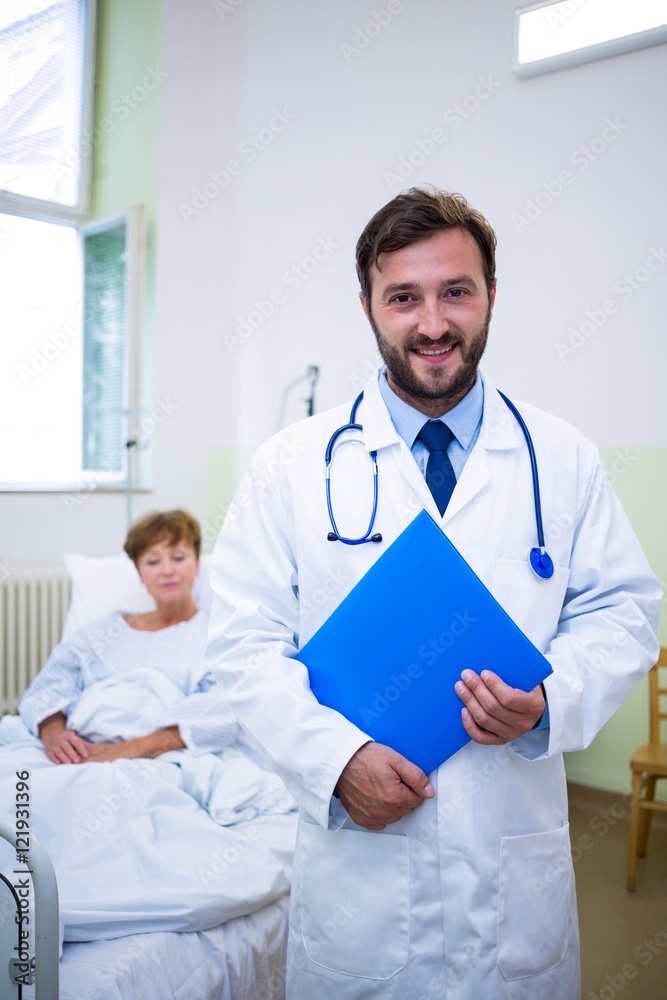 Smiling doctor holding a medical report Smiling doctor holding a medical report
