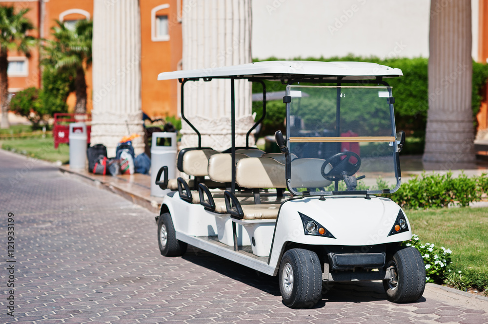 White golf car with back seat on resort.