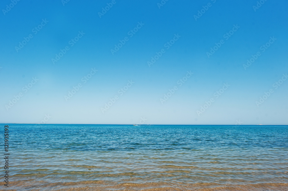 Running boat at blue sea on the horizon