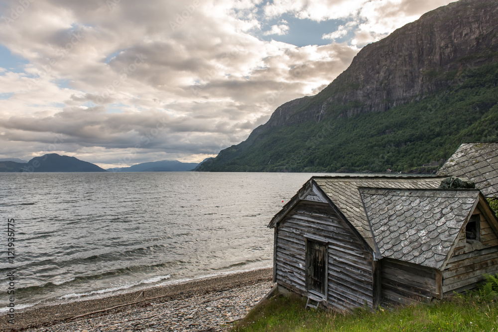 Old norwegian traditional house near fjord