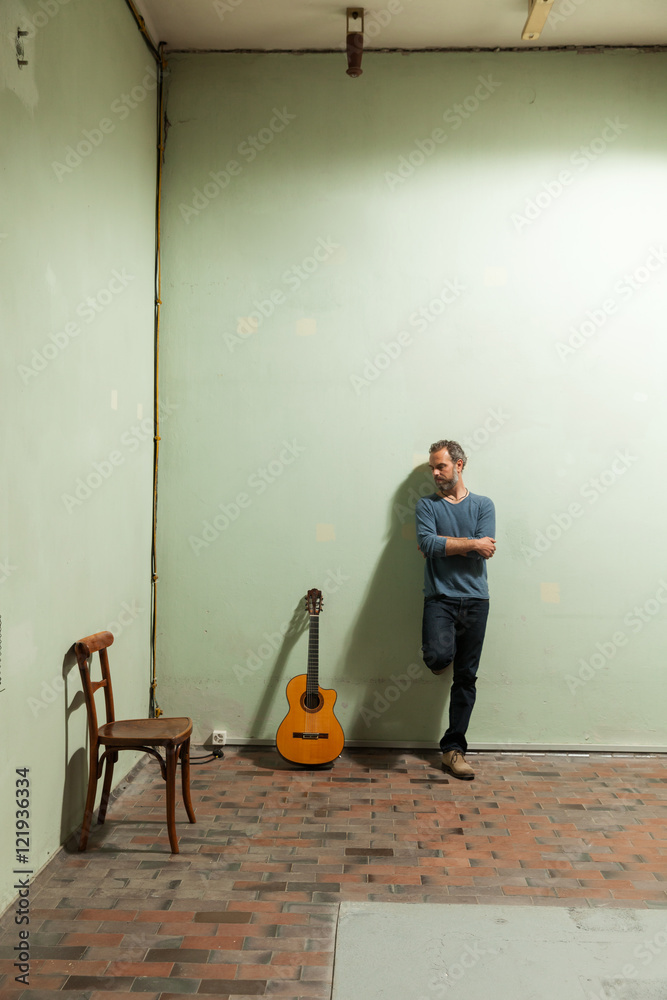 Portrait of man with guitar, the industrial location Portrait of man with guitar, the industrial location