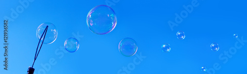 Soap bubbles against blue sky.