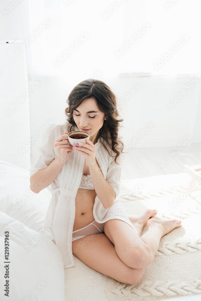 Girl drinking tea in bed in the morning Girl drinking tea in bed in the morning