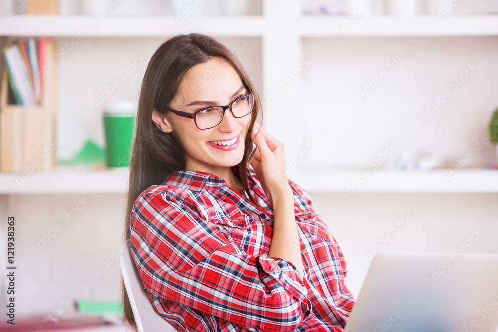 Woman on phone using laptop Woman on phone using laptop