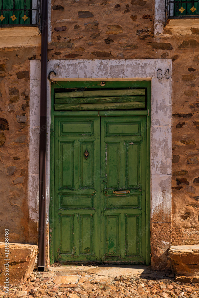 Fototapeta premium Antique wooden door in a stone house