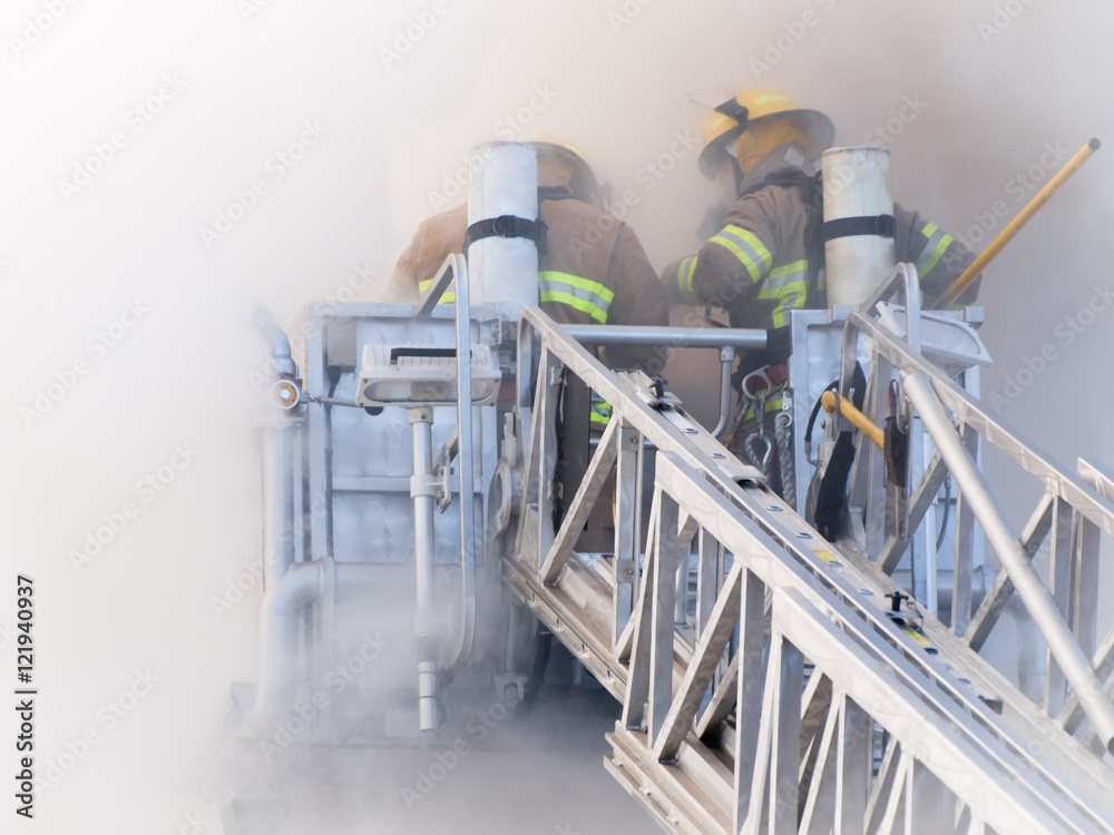 Firefighters on platform in heavy smoke