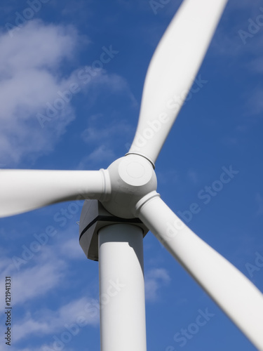 Wind turbine front view close-up on blue sky