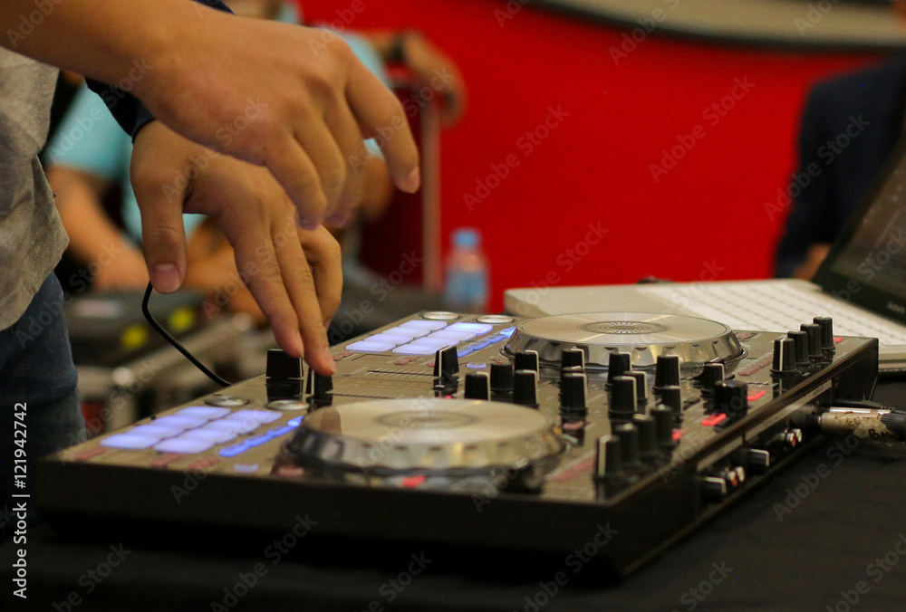 Fototapeta premium Dj mixes and playing the track controller turntable. New digital DJ technology for mixing audio tracks from notebook or flash drive.
