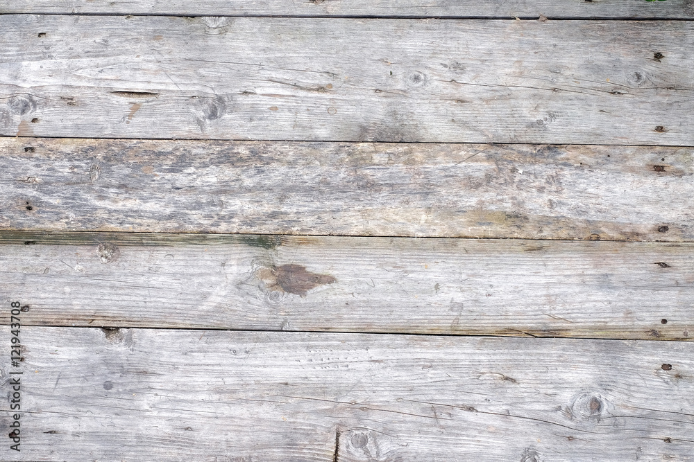 wooden background from old grey textured boards with little gap between it/different scale/hats of nails wooden background from old grey textured boards with little gap between it/different scale/hats of nails