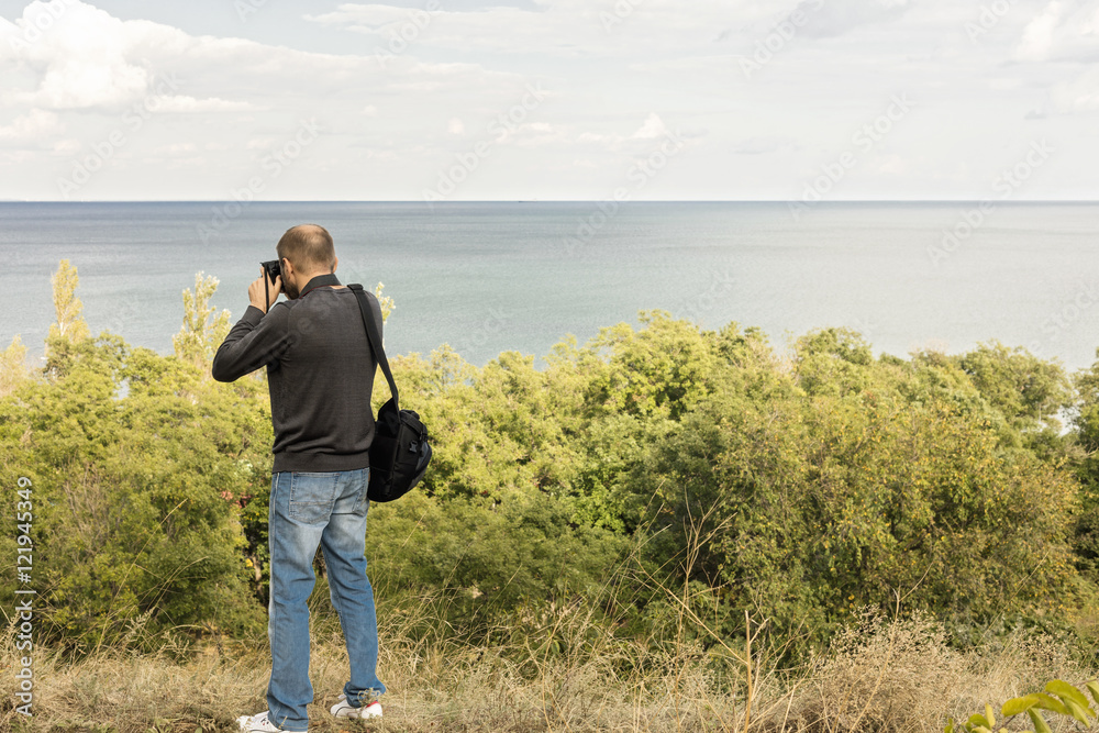 Beautiful sea landscape. A man photographs the sea and the sky. Beautiful sea landscape. A man photographs the sea and the sky.