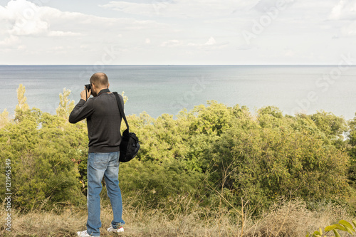 Beautiful sea landscape. A man photographs the sea and the sky.