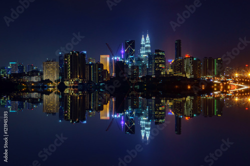 Majestic view of Kuala Lumpur city skyline at night with full reflection. © Mohamad Zaki