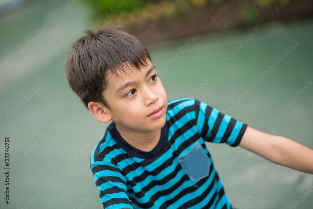 Little boy riding bicycle on the road around the house Little boy riding bicycle on the road around the house