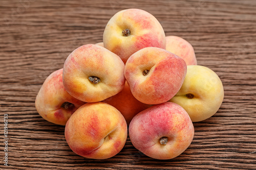 Fresh peaches on wooden background