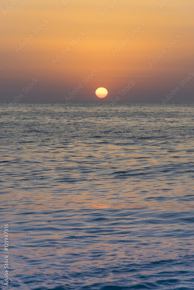 Orange yellow Sun sunsets over blue clear sky on the open sea 2 Orange yellow Sun sunsets over blue clear sky on the open sea 2