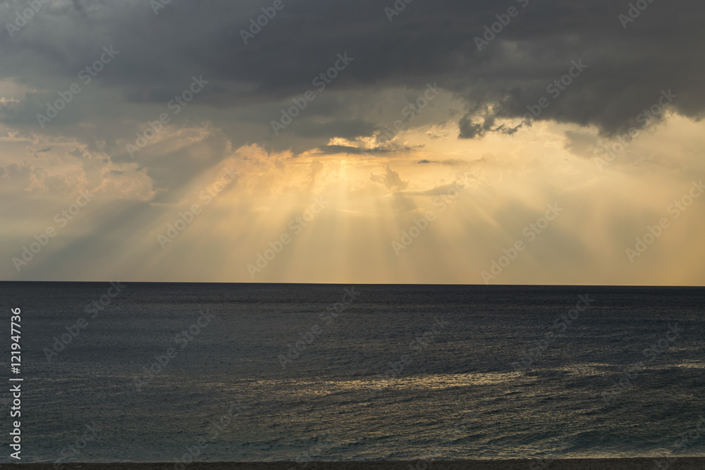 Dramatic sunset over cloudy sky and dark blue sea 1