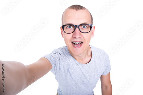 funny young man in glasses with braces on teeth taking selfie ph © Di Studio
