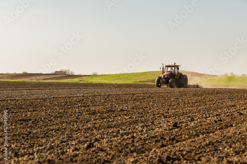 Farmer in tractor preparing land with seedbed cultivator © oticki