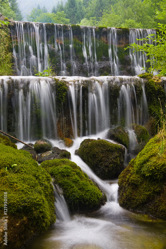 Water pouring out of swift barrier near Breginj, Slovenia