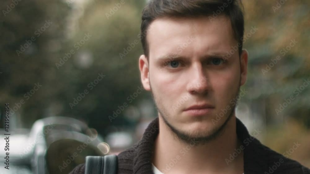 attractive young man with serious gaze looking into the camera: 4k footage attractive young man with serious gaze looking into the camera: 4k footage