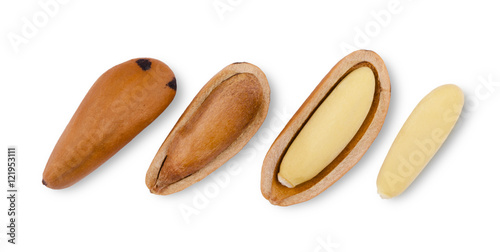 Stone pine seeds, nutshells and shelled nuts over white background. Pinophyta seeds in a row. Close up macro food photo from above on white background. photo