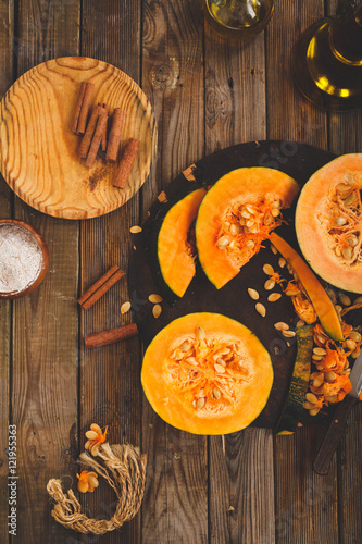 Slicing Pumpkin round for strudel on a rustic dark chalkboard 